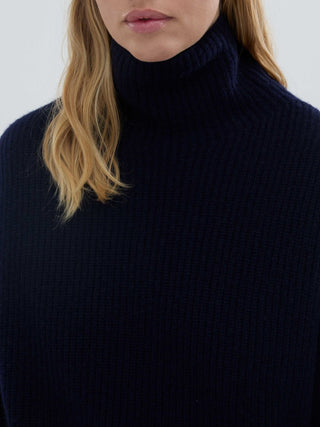 Navy blue premium ribbed turtleneck knitted in 7-gauge 100% Grade A Inner Mongolian cashmere, with a chunky texture, high neck, and relaxed oversized fit