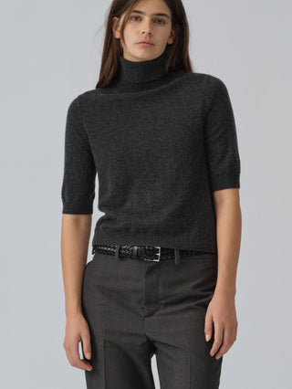 Dark grey women's turtleneck blouse in 100% Grade A Inner Mongolian cashmere, 12-gauge knit, featuring a ribbed turtle neckline, three-quarter sleeves, and a cropped fit