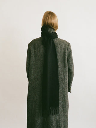 Black cashmere woven scarf with a smooth, slightly shiny finish and fringed ends