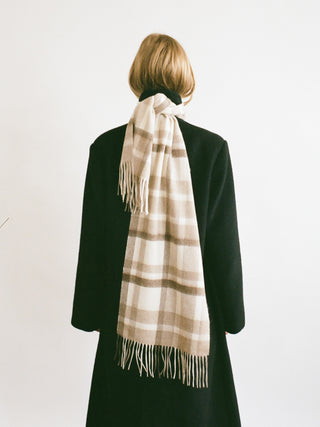 Checked Sand cashmere woven scarf with a smooth, slightly shiny finish, soft lightweight feel, and fringed ends