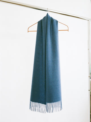 Petrol blue cashmere woven scarf with a smooth, slightly shiny finish and fringed ends